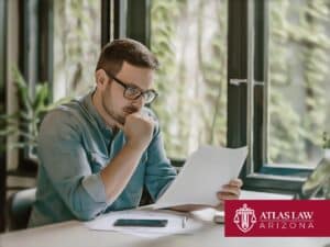 Man reading documents while considering bankruptcy options